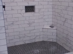 Custom marble subway tile shower with hexagon mosaic floor — recent Memphis remodel